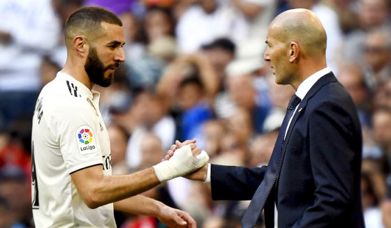 TOPSHOT - Real Madrid's French forward Karim Benzema (L) greets Real Madrid's French coach Zinedine Zidane as he leaves the pitch during the Spanish league football match between Real Madrid CF and RC Celta de Vigo at the Santiago Bernabeu stadium in Madrid on March 16, 2019. (Photo by GABRIEL BOUYS / AFP) (Photo credit should read GABRIEL BOUYS/AFP/Getty Images)