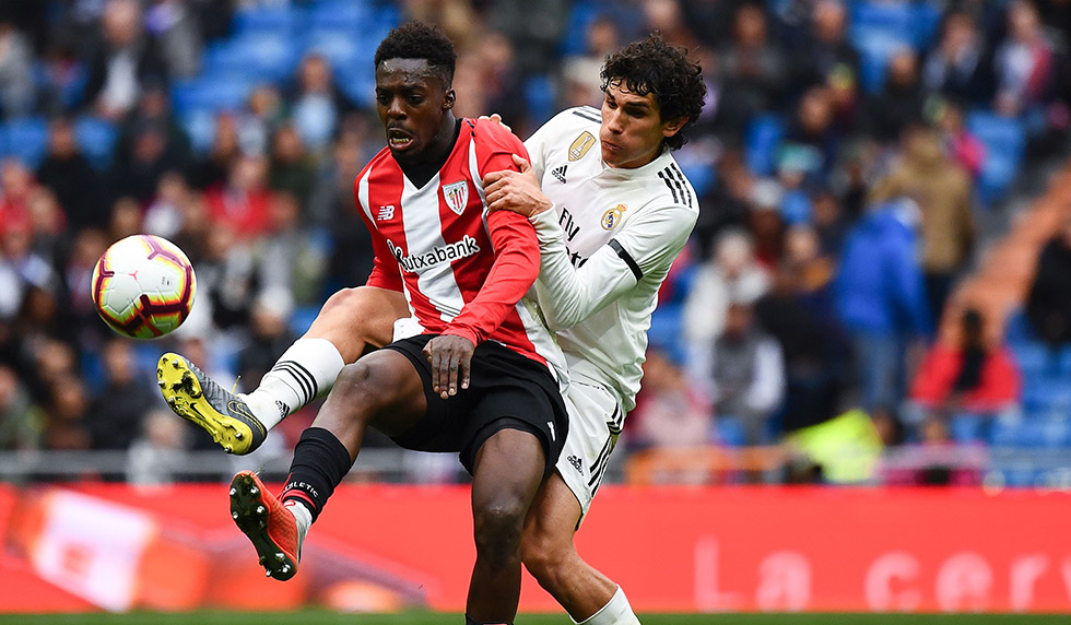 Athletic Bilbao's Spanish forward Inaki Williams (L) challenges Real Madrid's Spanish defender Jesus Vallejo during the Spanish League football match between Real Madrid and Athletic Bilbao at the Santiago Bernabeu Stadium in Madrid on April 21, 2019. (Photo by GABRIEL BOUYS / AFP) (Photo credit should read GABRIEL BOUYS/AFP/Getty Images)