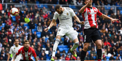 Real Madrid's French forward Karim Benzema (C) scores a header past Athletic Bilbao's Spanish defender Yeray Alvarez (R) during the Spanish League football match between Real Madrid and Athletic Bilbao at the Santiago Bernabeu Stadium in Madrid on April 21, 2019. (Photo by GABRIEL BOUYS / AFP) (Photo credit should read GABRIEL BOUYS/AFP/Getty Images)