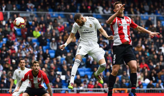 Real Madrid's French forward Karim Benzema (C) scores a header past Athletic Bilbao's Spanish defender Yeray Alvarez (R) during the Spanish League football match between Real Madrid and Athletic Bilbao at the Santiago Bernabeu Stadium in Madrid on April 21, 2019. (Photo by GABRIEL BOUYS / AFP) (Photo credit should read GABRIEL BOUYS/AFP/Getty Images)