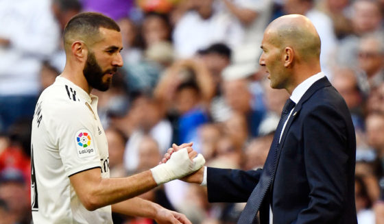 TOPSHOT - Real Madrid's French forward Karim Benzema (L) greets Real Madrid's French coach Zinedine Zidane as he leaves the pitch during the Spanish league football match between Real Madrid CF and RC Celta de Vigo at the Santiago Bernabeu stadium in Madrid on March 16, 2019. (Photo by GABRIEL BOUYS / AFP) (Photo credit should read GABRIEL BOUYS/AFP/Getty Images)