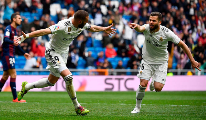 Real Madrid's French forward Karim Benzema (L) celebrates with Real Madrid's Spanish defender Nacho Fernandez after scoring a goal during the Spanish league football match between Real Madrid CF and SD Eibar at the Santiago Bernabeu stadium in Madrid on April 6, 2019. (Photo by GABRIEL BOUYS / AFP) (Photo credit should read GABRIEL BOUYS/AFP/Getty Images)