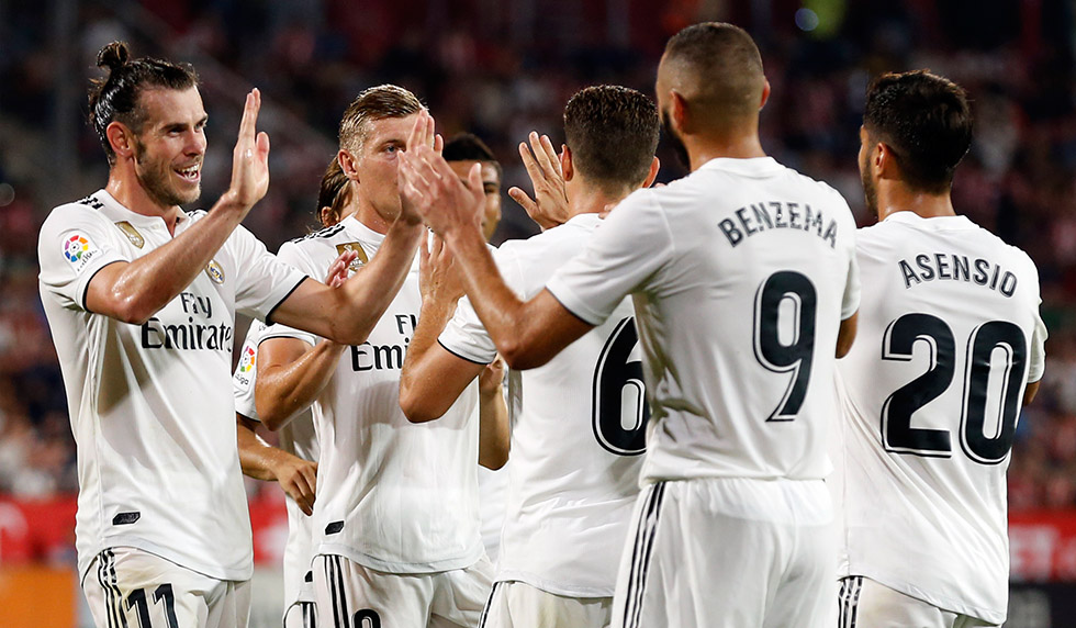 Real Madrid players celebrate their fourth goal scored by Real Madrid's French forward Karim Benzema during the Spanish league football match between Girona FC and Real Madrid CF at the Montilivi stadium in Girona on August 26, 2018. (Photo by Pau BARRENA CAPILLA / AFP) (Photo credit should read PAU BARRENA CAPILLA/AFP/Getty Images)