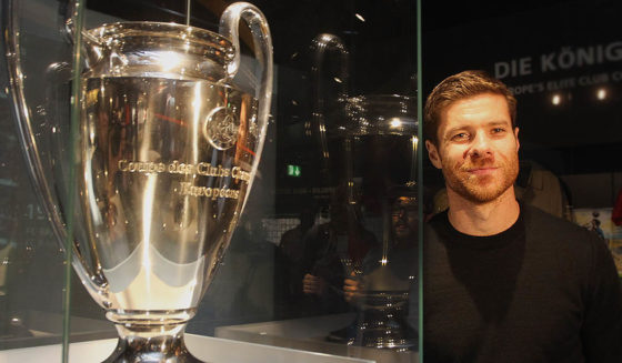 Xabi Alonso MUNICH, GERMANY - OCTOBER 14: FC Bayern Muenchen player Xabi Alonso stands next to the Champions League trophy during his visit at the FC Bayern Erlebniswelt museum at Allianz Arena on October 14, 2014 in Munich, Germany. (Photo by Alexandra Beier/Bongarts/Getty Images)