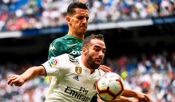 Daniel Carvajal Real Betis' Moroccan defender Zouhair Feddal (back) challenges Real Madrid's Spanish defender Dani Carvajal during the Spanish League football match between Real Madrid and Real Betis at the Santiago Bernabeu stadium in Madrid on May 19, 2019. (Photo by PIERRE-PHILIPPE MARCOU / AFP) (Photo credit should read PIERRE-PHILIPPE MARCOU/AFP/Getty Images)