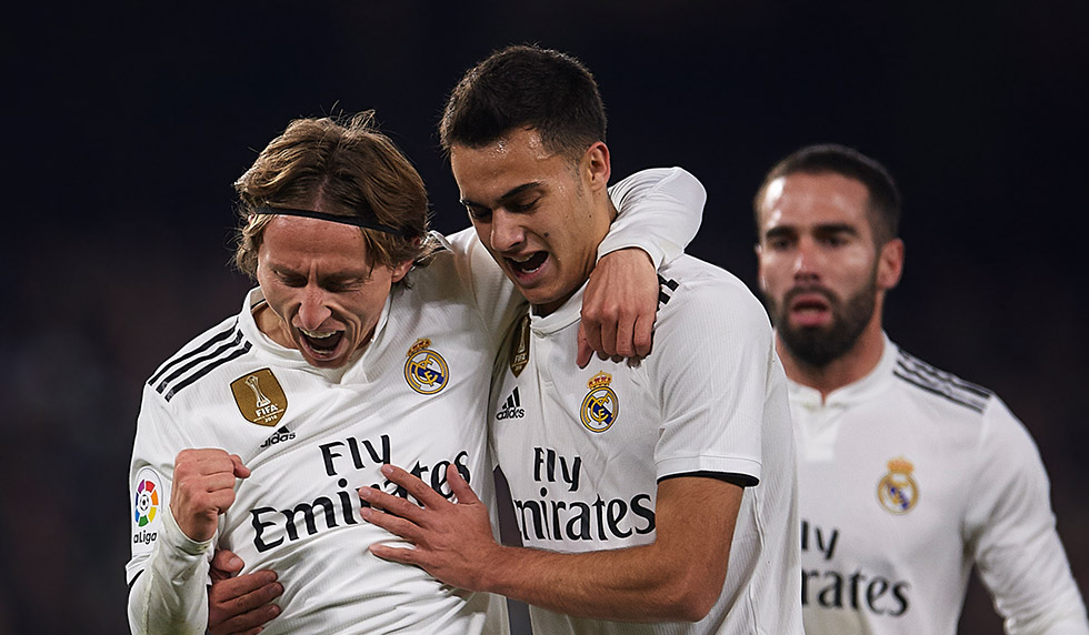 SEVILLE, SPAIN - JANUARY 13: Luka Modric of Real Madrid CF (L) celebrates after scoring with Sergio Reguilon of Real Madrid CF (R) during the La Liga match between Real Betis Balompie and Real Madrid CF at Estadio Benito Villamarin on January 13, 2019 in Seville, Spain. (Photo by Aitor Alcalde/Getty Images)
