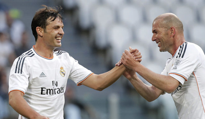 Real Madrid's forward Sanchez Fernando Morientes (L) celebrates with his teammate Zinedine Zidane after scoring during the Unesco Cup football match Juventus Legends vs Real Madrid Leyendas on June 2, 2014 in Juventus Stadium in Turin. AFP PHOTO / MARCO BERTORELLO (Photo credit should read MARCO BERTORELLO/AFP/Getty Images)