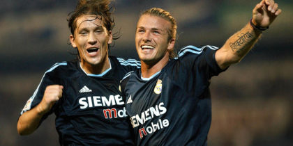 Real Madrid Briton David Beckham (R) celebrates his goal against Malaga with Michel Salgado (L) during a Liga match at La Rosaleda stadium in Malaga 21 September 2003. (Photo credit should read CRISTINA QUICLER/AFP/Getty Images)