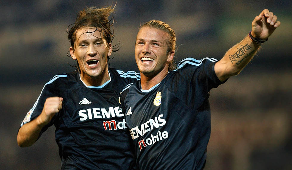 Real Madrid Briton David Beckham (R) celebrates his goal against Malaga with Michel Salgado (L) during a Liga match at La Rosaleda stadium in Malaga 21 September 2003. (Photo credit should read CRISTINA QUICLER/AFP/Getty Images)