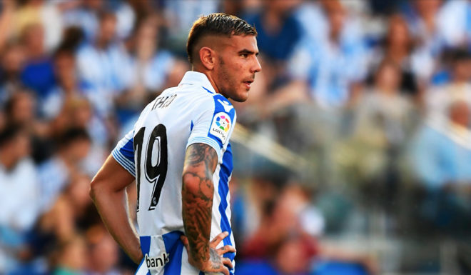 Barcelona's Argentinian forward Lionel Messi (R) and Real Sociedad's French defender Theo Hernandez react during the Spanish league football match between Real Sociedad and FC Barcelona at the Anoeta stadium in San Sebastian on September 15, 2018. (Photo by GABRIEL BOUYS / AFP) (Photo credit should read GABRIEL BOUYS/AFP/Getty Images)