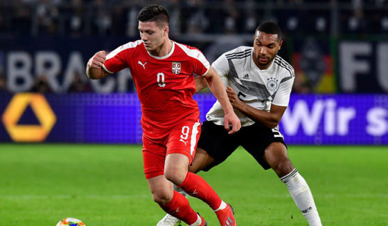 Serbia's forward Luka Jovic (L) and Germany's defender Jonathan Tah vie for the ball during the friendly football match Germany v Serbia in Wolfsburg, western Germany on March 20, 2019. (Photo by Tobias SCHWARZ / AFP) / RESTRICTIONS: ACCORDING TO DFB RULES IMAGE SEQUENCES TO SIMULATE VIDEO IS NOT ALLOWED DURING MATCH TIME. MOBILE (MMS) USE IS NOT ALLOWED DURING AND FOR FURTHER TWO HOURS AFTER THE MATCH. == RESTRICTED TO EDITORIAL USE == FOR MORE INFORMATION CONTACT DFB DIRECTLY AT +49 69 67880 / (Photo credit should read TOBIAS SCHWARZ/AFP/Getty Images)