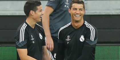 Real Madrid's Portuguese forward Cristiano Ronaldo (R) jokes with Real Madrid's Colombian midfielder James Rodriguez during a training session on the eve of the UEFA Champions League semi final football match Juventus vs Real Madrid on May 4, 2015 at the "Juventus Stadium" in Turin. AFP PHOTO / MARCO BERTORELLO (Photo credit should read MARCO BERTORELLO/AFP/Getty Images)