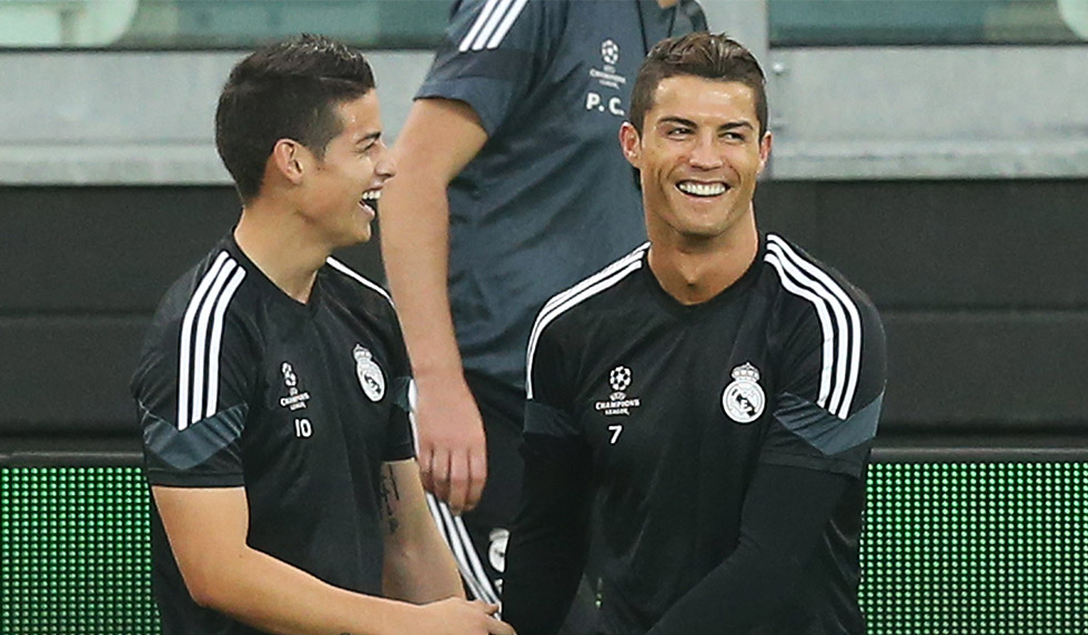 Real Madrid's Portuguese forward Cristiano Ronaldo (R) jokes with Real Madrid's Colombian midfielder James Rodriguez during a training session on the eve of the UEFA Champions League semi final football match Juventus vs Real Madrid on May 4, 2015 at the "Juventus Stadium" in Turin. AFP PHOTO / MARCO BERTORELLO (Photo credit should read MARCO BERTORELLO/AFP/Getty Images)