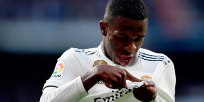 Real Madrid's Brazilian forward Vinicius Junior points at his jersey's badge to celebrate Valladolid's own goal during the Spanish league football match between Real Madrid CF and Real Valladolid FC at the Santiago Bernabeu stadium in Madrid on November 3, 2018. (Photo by JAVIER SORIANO / AFP) / The erroneous mention[s] appearing in the metadata of this photo by JAVIER SORIANO has been modified in AFP systems in the following manner: [to celebrate Valladolid's own goal] instead of [after scoring a goal]. Please immediately remove the erroneous mention[s] from all your online services and delete it (them) from your servers. If you have been authorized by AFP to distribute it (them) to third parties, please ensure that the same actions are carried out by them. Failure to promptly comply with these instructions will entail liability on your part for any continued or post notification usage. Therefore we thank you very much for all your attention and prompt action. We are sorry for the inconvenience this notification may cause and remain at your disposal for any further information you may require. (Photo credit should read JAVIER SORIANO/AFP/Getty Images)