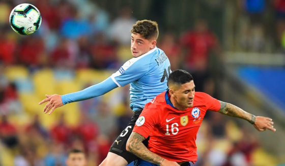 Uruguay's Federico Valverde (L) and Chile's Pedro Pablo Hernandez jump for the ball during their Copa America football tournament group match at Maracana Stadium in Rio de Janeiro, Brazil, on June 24, 2019. (Photo by Carl DE SOUZA / AFP) (Photo credit should read CARL DE SOUZA/AFP/Getty Images)