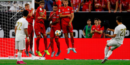 Bayern Munich players use their bodies to deflect a free kick by Real Madrid forward Marco Asensio (R) during their International Champions Cup match on July 20, 2019 at NRG Stadium in Houston, Texas. (Photo by AARON M. SPRECHER / AFP) (Photo credit should read AARON M. SPRECHER/AFP/Getty Images)