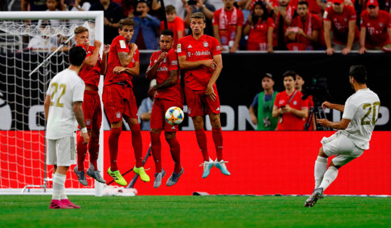 Bayern Munich players use their bodies to deflect a free kick by Real Madrid forward Marco Asensio (R) during their International Champions Cup match on July 20, 2019 at NRG Stadium in Houston, Texas. (Photo by AARON M. SPRECHER / AFP) (Photo credit should read AARON M. SPRECHER/AFP/Getty Images)
