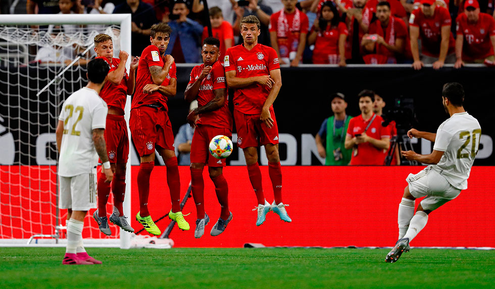 Bayern Munich players use their bodies to deflect a free kick by Real Madrid forward Marco Asensio (R) during their International Champions Cup match on July 20, 2019 at NRG Stadium in Houston, Texas. (Photo by AARON M. SPRECHER / AFP) (Photo credit should read AARON M. SPRECHER/AFP/Getty Images)