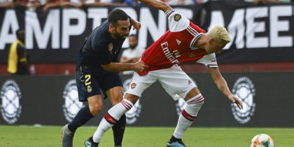 Real Madrid's Spanish defender Dani Carvajal (L) and Arsenal's German midfielder Mesut Ozil fight for the ball during the International Champions Cup football match between Real Madrid and Arsenal at FedExField in Landover, Maryland, on July 23, 2019. (Photo by ANDREW CABALLERO-REYNOLDS / AFP) (Photo credit should read ANDREW CABALLERO-REYNOLDS/AFP/Getty Images)