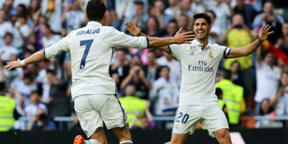 Real Madrid's Portuguese forward Cristiano Ronaldo (L) celebrates a goal with Real Madrid's midfielder Marco Asensio during the Spanish league football match Real Madrid CF vs Sevilla FC at the Santiago Bernabeu stadium in Madrid on May 14, 2017. / AFP PHOTO / CESAR MANSO (Photo credit should read CESAR MANSO/AFP/Getty Images)