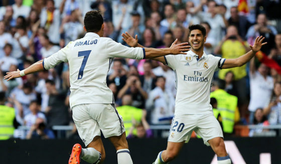 Real Madrid's Portuguese forward Cristiano Ronaldo (L) celebrates a goal with Real Madrid's midfielder Marco Asensio during the Spanish league football match Real Madrid CF vs Sevilla FC at the Santiago Bernabeu stadium in Madrid on May 14, 2017. / AFP PHOTO / CESAR MANSO (Photo credit should read CESAR MANSO/AFP/Getty Images)