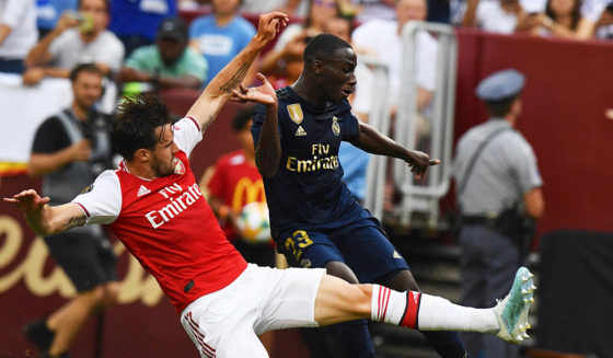 Arsenal's English defender Carl Jenkinson (L) fights for the ball with Real Madrid's French defender Ferland Mendy during the International Champions Cup football match between Real Madrid and Arsenal at FedExField in Landover, Maryland, on July 23, 2019. (Photo by Jim WATSON / AFP) (Photo credit should read JIM WATSON/AFP/Getty Images)