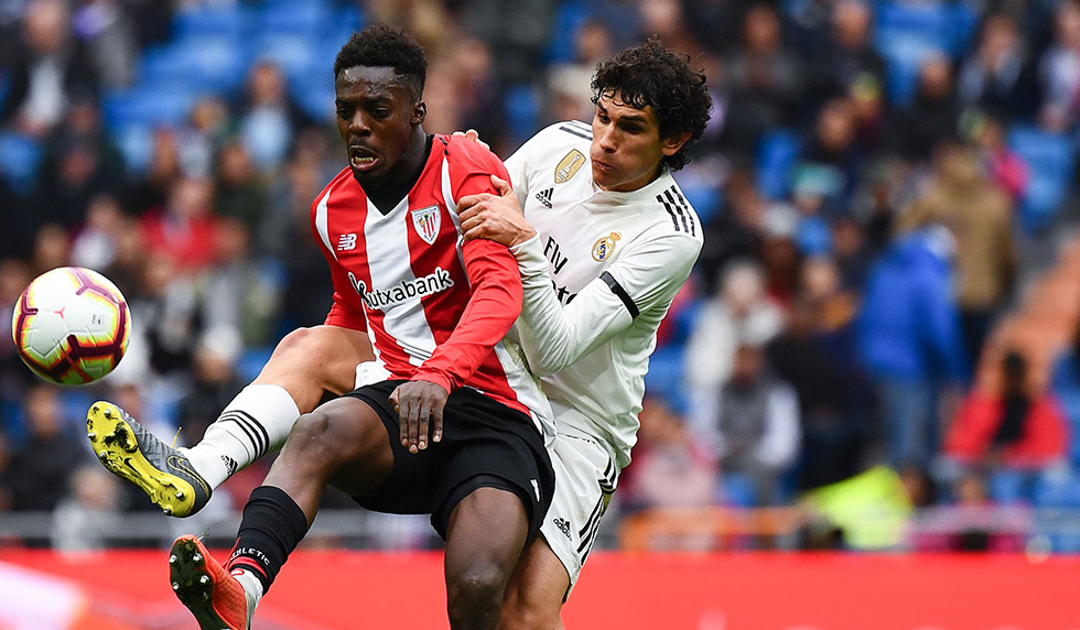 Athletic Bilbao's Spanish forward Inaki Williams (L) challenges Real Madrid's Spanish defender Jesus Vallejo during the Spanish League football match between Real Madrid and Athletic Bilbao at the Santiago Bernabeu Stadium in Madrid on April 21, 2019. (Photo by GABRIEL BOUYS / AFP) (Photo credit should read GABRIEL BOUYS/AFP/Getty Images)