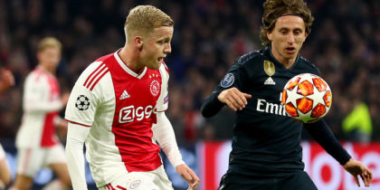 AMSTERDAM, NETHERLANDS - FEBRUARY 13: Donny van de Beek challenges Luka Modric of Madrid during the UEFA Champions League Round of 16 First Leg match between Ajax and Real Madrid at Johan Cruyff Arena on February 13, 2019 in Amsterdam, . (Photo by Lars Baron/Getty Images)