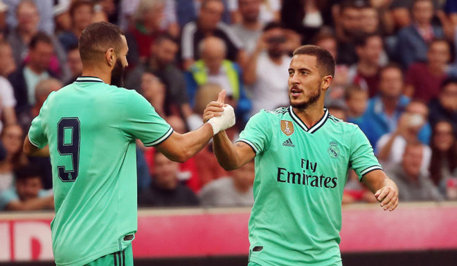 Real Madrid's forward Eden Hazard celebrates scoring with his team-mate Real Madrid's French forward Karim Benzema (L) during the pre-Season friendly football match FC Red Bull Salzburg v Real Madrid in Salzburg, Austria on August 7, 2019. (Photo by KRUGFOTO / APA / AFP) / Austria OUT (Photo credit should read KRUGFOTO/AFP/Getty Images)