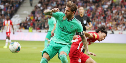 Real Madrid's Spanish defender Sergio Ramos (L) vies for the ball Red Bull Salzburg's Japanese forward Takumi Minamino during the pre-Season friendly football match FC Red Bull Salzburg v Real Madrid in Salzburg, Austria on August 7, 2019. - Sergio Garcia Ramos (Real Madrid CF/li) gegen Takumi Minamino (Photo by KRUGFOTO / APA / AFP) / Austria OUT (Photo credit should read KRUGFOTO/AFP/Getty Images)