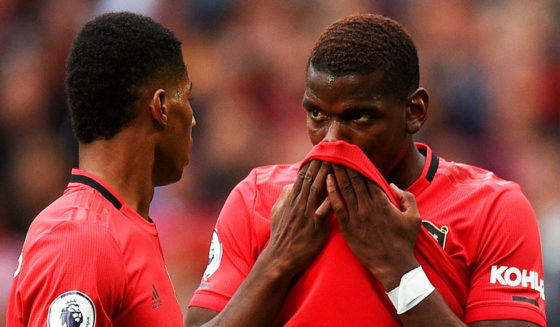 Manchester United's English striker Marcus Rashford (L) and Manchester United's French midfielder Paul Pogba (R) talk before Rashford takes a penalty and scores the opening goal during the English Premier League football match between Manchester United and Chelsea at Old Trafford in Manchester, north west England, on August 11, 2019. (Photo by Oli SCARFF / AFP) / RESTRICTED TO EDITORIAL USE. No use with unauthorized audio, video, data, fixture lists, club/league logos or 'live' services. Online in-match use limited to 120 images. An additional 40 images may be used in extra time. No video emulation. Social media in-match use limited to 120 images. An additional 40 images may be used in extra time. No use in betting publications, games or single club/league/player publications. / (Photo credit should read OLI SCARFF/AFP/Getty Images)