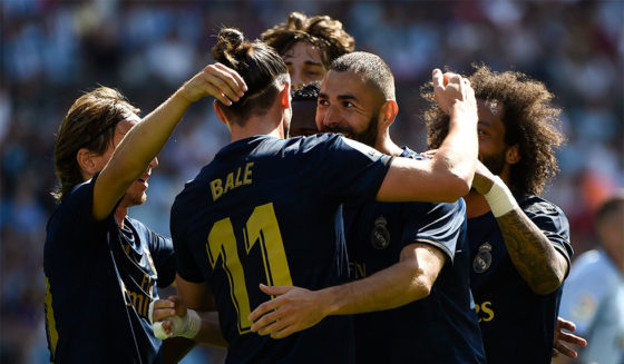 Real Madrid's French forward Karim Benzema (C) celebrates with teammates after scoring a goal during the Spanish League football match between Celta Vigo and Real Madrid at the Balaidos Stadium in Vigo on August 17, 2019. (Photo by MIGUEL RIOPA / AFP) (Photo credit should read MIGUEL RIOPA/AFP/Getty Images)