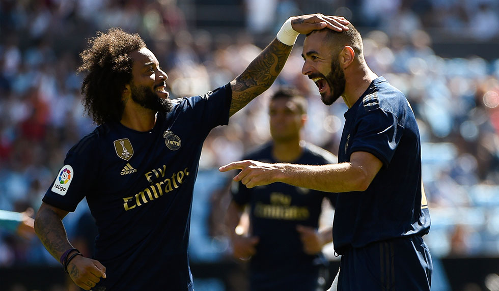 Real Madrid's French forward Karim Benzema (R) celebrates with Real Madrid's Brazilian defender Marcelo after scoring a goal during the Spanish League football match between Celta Vigo and Real Madrid at the Balaidos Stadium in Vigo on August 17, 2019. (Photo by MIGUEL RIOPA / AFP) (Photo credit should read MIGUEL RIOPA/AFP/Getty Images)