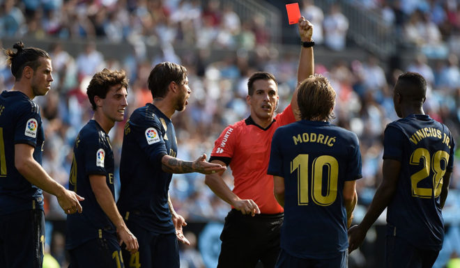 Real Madrid's Croatian midfielder Luka Modric (2ndR) receives a red card from Spanish referee Xavier Estrada Fernandez during the Spanish League football match between Celta Vigo and Real Madrid at the Balaidos Stadium in Vigo on August 17, 2019. (Photo by MIGUEL RIOPA / AFP) (Photo credit should read MIGUEL RIOPA/AFP/Getty Images)