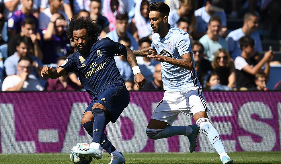 VIGO, SPAIN - AUGUST 17: Brais Mendez of RC Celta competes for the ball with Marcelo of Real Madrid during the Liga match between RC Celta de Vigo and Real Madrid CF at Abanca-Balaídos on August 17, 2019 in Vigo, Spain. (Photo by Octavio Passos/Getty Images)