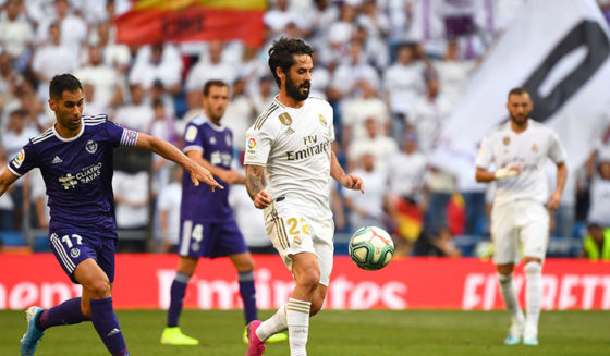 Valladolid's Spanish defender Javi Moyano (L) challenges Real Madrid's Spanish midfielder Isco (C) during the Spanish League football match between Real Madrid and Real Valladolid at the Santiago Bernabeu stadium in Madrid on August 24, 2019. (Photo by GABRIEL BOUYS / AFP) (Photo credit should read GABRIEL BOUYS/AFP/Getty Images)