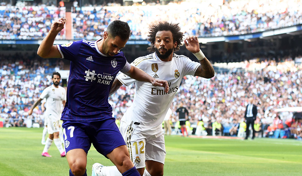 MADRID, SPAIN - AUGUST 24: Javi Moyano of Real Valladolid is tackled by Marcelo of Real Madrid during the La Liga match between Real Madrid CF and Real Valladolid CF at Estadio Santiago Bernabeu on August 24, 2019 in Madrid, Spain. (Photo by Denis Doyle/Getty Images)