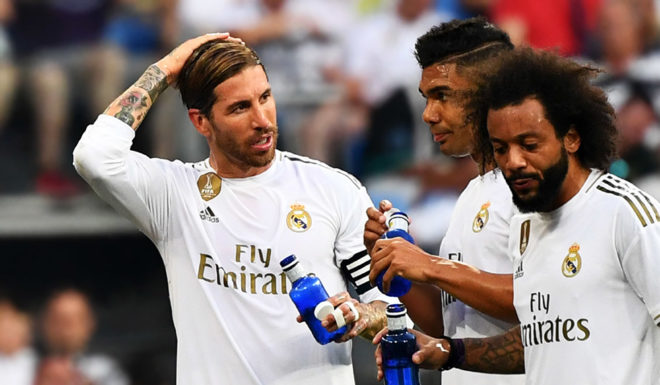 Real Madrid's French coach Zinedine Zidane (L) talks to Real Madrid's Spanish defender Sergio Ramos, Real Madrid's Brazilian midfielder Casemiro and Real Madrid's Brazilian defender Marcelo during the Spanish League football match between Real Madrid and Real Valladolid at the Santiago Bernabeu stadium in Madrid on August 24, 2019. (Photo by GABRIEL BOUYS / AFP) (Photo credit should read GABRIEL BOUYS/AFP/Getty Images)