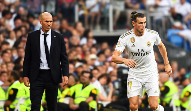Real Madrid's French coach Zinedine Zidane (L) looks at Real Madrid's Welsh forward Gareth Bale (R) during the Spanish League football match between Real Madrid and Real Valladolid at the Santiago Bernabeu stadium in Madrid on August 24, 2019. (Photo by GABRIEL BOUYS / AFP) (Photo credit should read GABRIEL BOUYS/AFP/Getty Images)