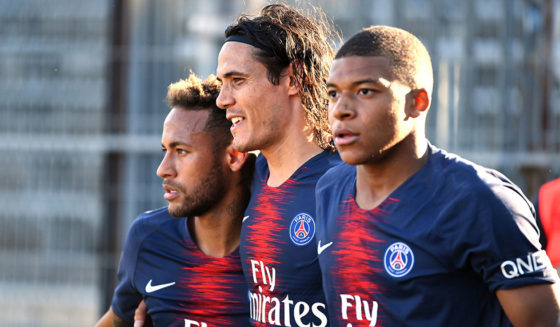 Paris Saint-Germain's French forward Kylian Mbappe (R) celebrates with Paris Saint-Germain's Uruguayan forward Edinson Cavani (C) and Paris Saint-Germain's Brazilian forward Neymar Jr (L) after scoring their third goal during the French L1 football match between Nimes and Paris Saint-Germain (PSG), on September 1, 2018 at the Costieres stadium in Nimes, southern France. (Photo by PASCAL GUYOT / AFP) (Photo credit should read PASCAL GUYOT/AFP/Getty Images)