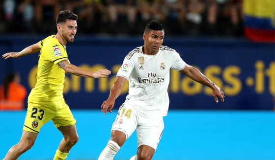 VILLAREAL, SPAIN - SEPTEMBER 01: Casemiro of Real Madrid is tackled by Moi Gomez of Villarreal during the Liga match between Villarreal CF and Real Madrid CF at Estadio de la Ceramica on September 01, 2019 in Villareal, Spain. (Photo by David Ramos/Getty Images)