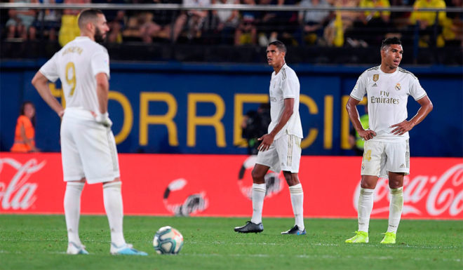 (FromL) Real Madrid's French forward Karim Benzema, Real Madrid's French defender Raphael Varane and Real Madrid's Brazilian midfielder Casemiro react after Villarreal's Spanish midfielder Moises Gomez scored a goal during the Spanish league football match Villarreal CF against Real Madrid CF at La Ceramica stadium in Vila-real on September 1, 2019. (Photo by Josep LAGO / AFP) (Photo credit should read JOSEP LAGO/AFP/Getty Images)