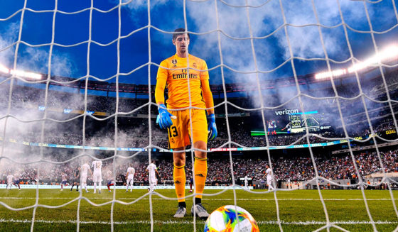 Real Madrid's Belgian goalkeeper Thibaut Courtois takes the ball after failing to save a goal during the 2019 International Champions Cup football match between Real Madrid and Atletico Madrid at the Metlife Stadium Arena in East Rutherford, New Jersey on July 26, 2019. (Photo by Johannes EISELE / AFP) (Photo credit should read