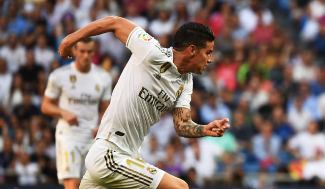 Real Madrid's Colombian midfielder James Rodriguez (L) challenges Valladolid's Spanish midfielder Oscar Plano (R) during the Spanish League football match between Real Madrid and Real Valladolid at the Santiago Bernabeu stadium in Madrid on August 24, 2019. (Photo by GABRIEL BOUYS / AFP) (Photo credit should read GABRIEL BOUYS/AFP/Getty Images)