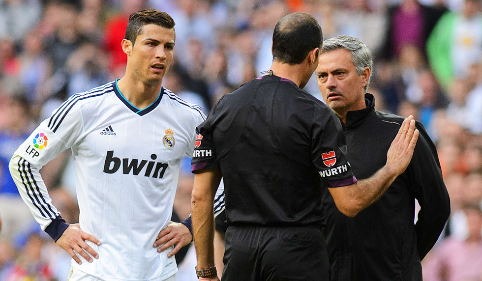 Real Madrid's Portuguese forward Cristiano Ronaldo and Real Madrid's Portuguese coach Jose Mourinho argue with the referee during the Spanish league football match Real Madrid CF vs Real Betis at the Santiago Bernabeu stadium in Madrid on April 20, 2013. AFP PHOTO / DANI POZO (Photo credit should read DANI POZO/AFP/Getty Images)