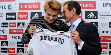 MADRID, SPAIN - JANUARY 22: Martin Odegaard from Norway holds his new Real Madrid shirt with former Real player Emilio Butragueno during a press conference at Real Madrid's Valdebebas training grounds after he signed with Real on January 22, 2015 in Madrid, Spain. (Photo by Denis Doyle/Getty Images)