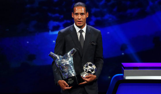 Virgil van Dijk Liverpool's Dutch defender Virgil van Dijk poses with his trophy of Best Men's player in Europe of the Year and Best Defender at the end of the UEFA Champions League football group stage draw ceremony in Monaco on August 29, 2019. (Photo by Valery HACHE / AFP) (Photo credit should read VALERY HACHE/AFP/Getty Images)