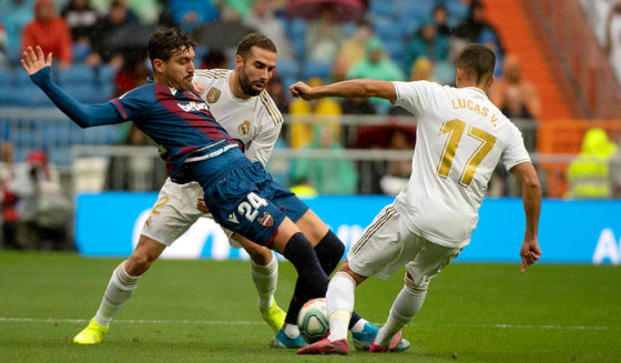 Levante's Spanish midfielder Jose Campana (L) vies with Real Madrid's Spanish forward Lucas Vazquez (R) and Real Madrid's Spanish midfielder Isco during the Spanish league football match Real Madrid CF against Levante UD at the Santiago Bernabeu stadium in Madrid on September 14, 2019. (Photo by CURTO DE LA TORRE / AFP) (Photo credit should read CURTO DE LA TORRE/AFP/Getty Images)