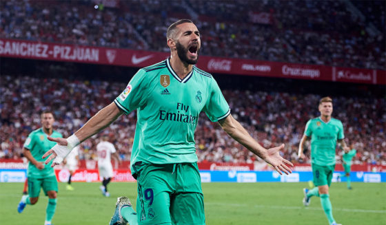 SEVILLE, SPAIN - SEPTEMBER 22: Karim Benzema of Real Madrid CF celebrates after scoring a goal during the Liga match between Sevilla FC and Real Madrid CF at Estadio Ramon Sanchez Pizjuan on September 22, 2019 in Seville, Spain. (Photo by Aitor Alcalde/Getty Images)