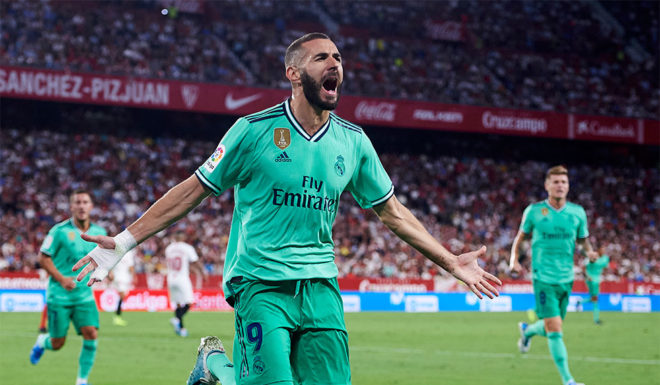 SEVILLE, SPAIN - SEPTEMBER 22: Karim Benzema of Real Madrid CF celebrates after scoring a goal during the Liga match between Sevilla FC and Real Madrid CF at Estadio Ramon Sanchez Pizjuan on September 22, 2019 in Seville, Spain. (Photo by Aitor Alcalde/Getty Images)